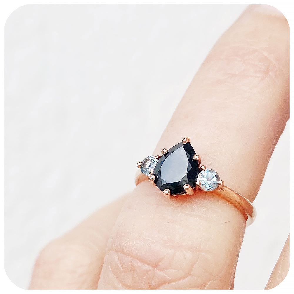 black pear cut spinel and round cut aquamarine trilogy style engagement ring in rose gold - Victoria's Jewellery