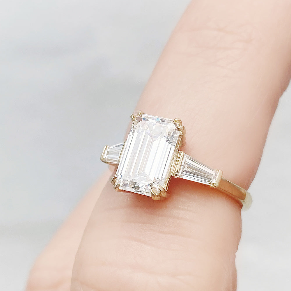 Carmen, an Emerald cut Trilogy Ring
