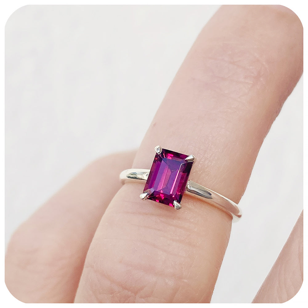 Mari, an Emerald cut Rhodolite Solitaire Ring