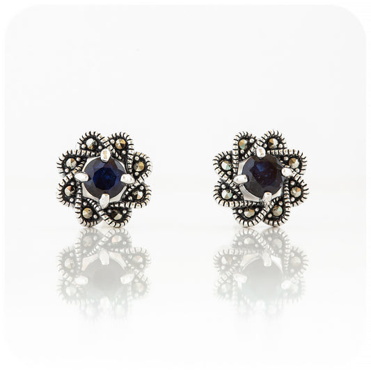round cut dark blue sapphire stud earrings in a vintage flower design
