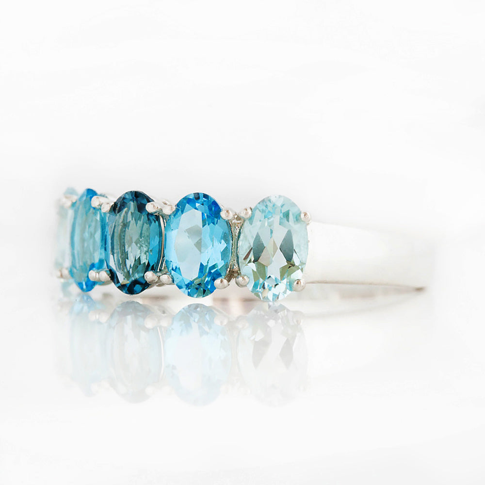 Oval cut Blue Topaz Rainbow half eternity ring - Victoria's Jewellery