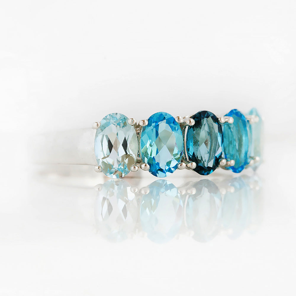 Oval cut Blue Topaz Rainbow half eternity ring - Victoria's Jewellery