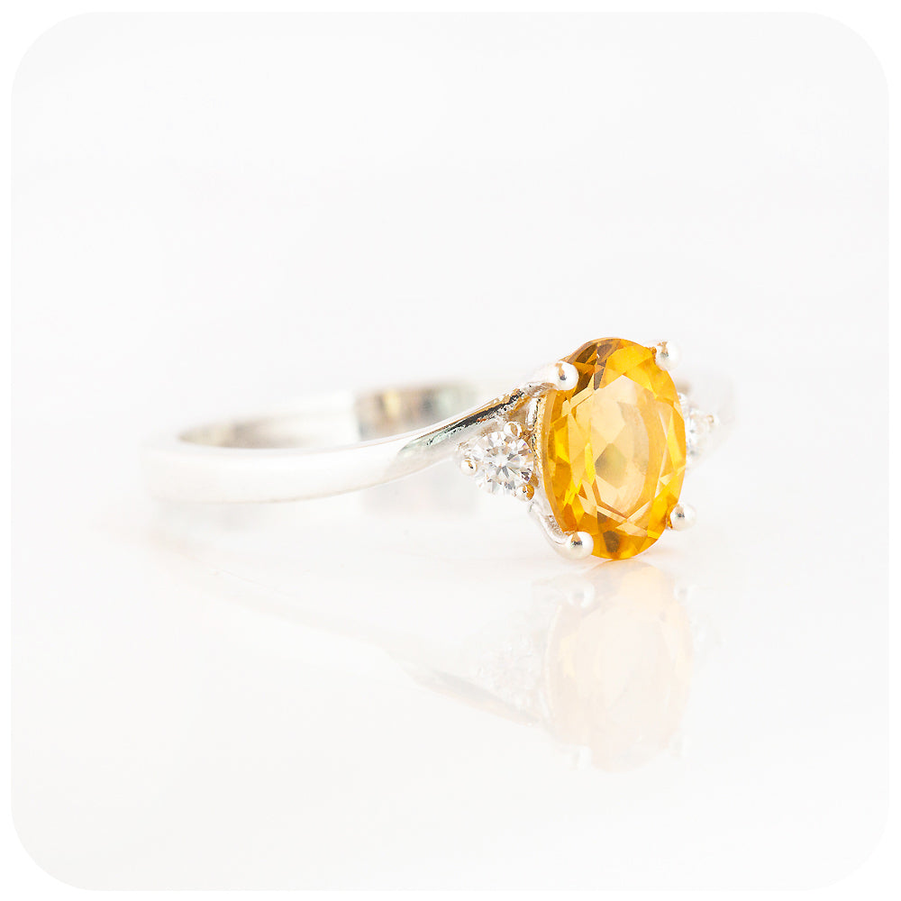 Oval cut Citrine and Moissanite Trilogy Ring with a Twist