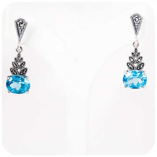 oval cut swiss blue topaz drop earrings in sterling silver with a vintage art deco design
