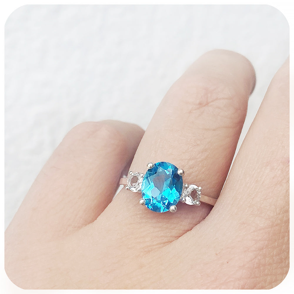 Oval cut Swiss Blue Topaz and White Quartz Trilogy Anniversary Ring - Victoria's Jewellery
