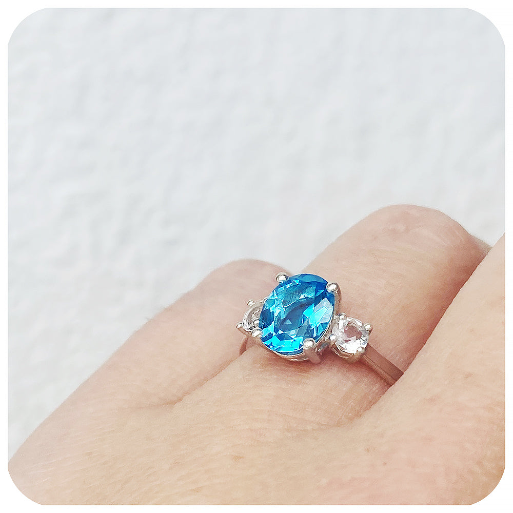 Oval cut Swiss Blue Topaz and White Quartz Trilogy Anniversary Ring - Victoria's Jewellery