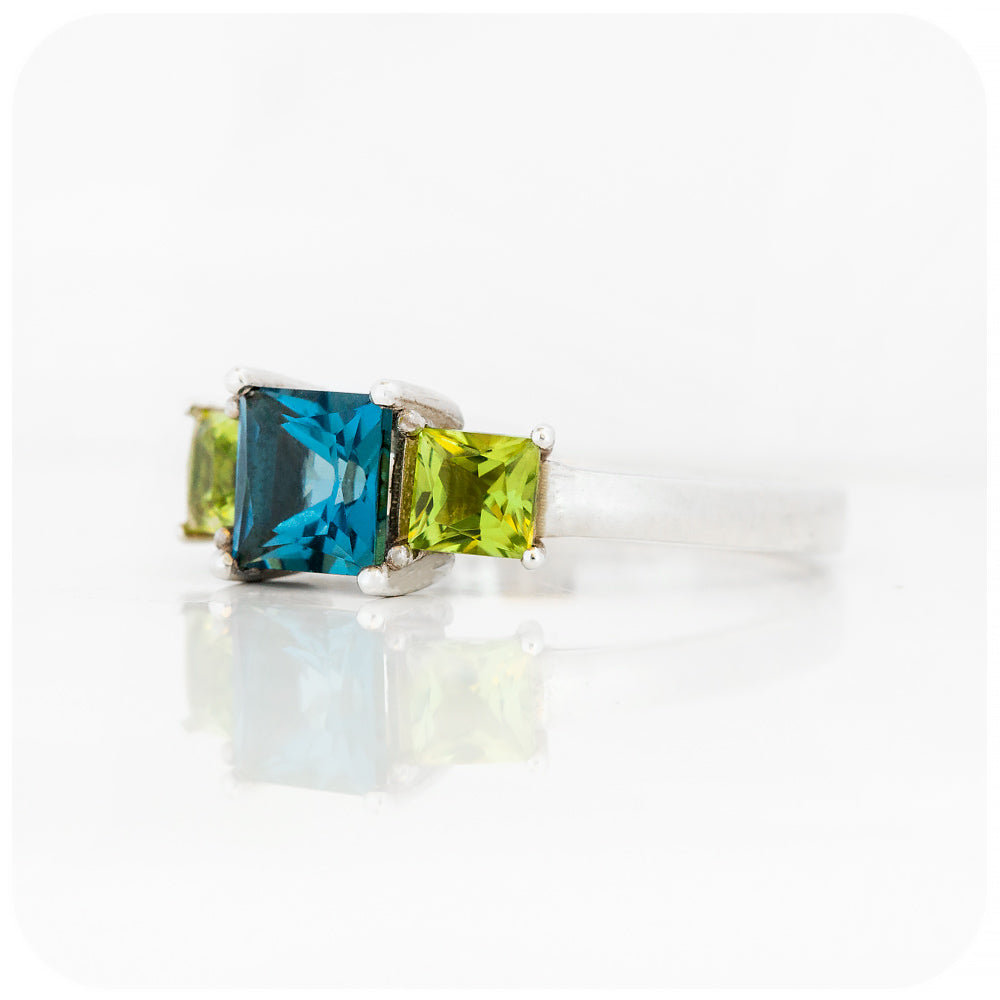 Princess cut London Blue Topaz and Peridot Trilogy Ring - Victoria's Jewellery