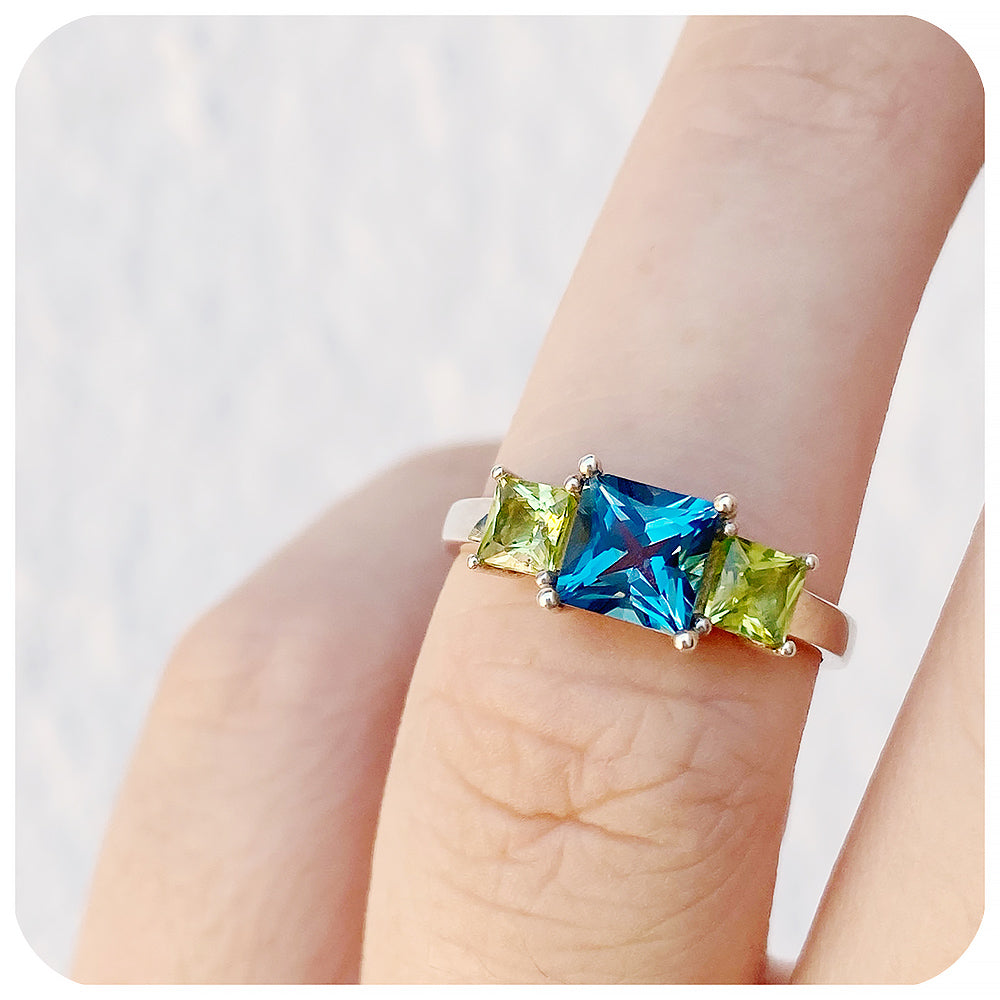 Princess cut London Blue Topaz and Peridot Trilogy Ring - Victoria's Jewellery
