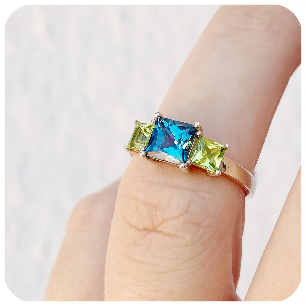 Princess cut London Blue Topaz and Peridot Trilogy Ring - Victoria's Jewellery