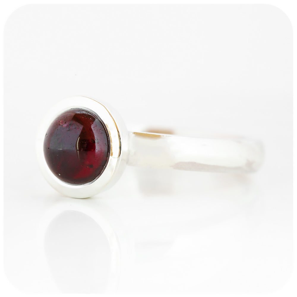 round cabochon rhodolite solitaire ring in a bezel setting