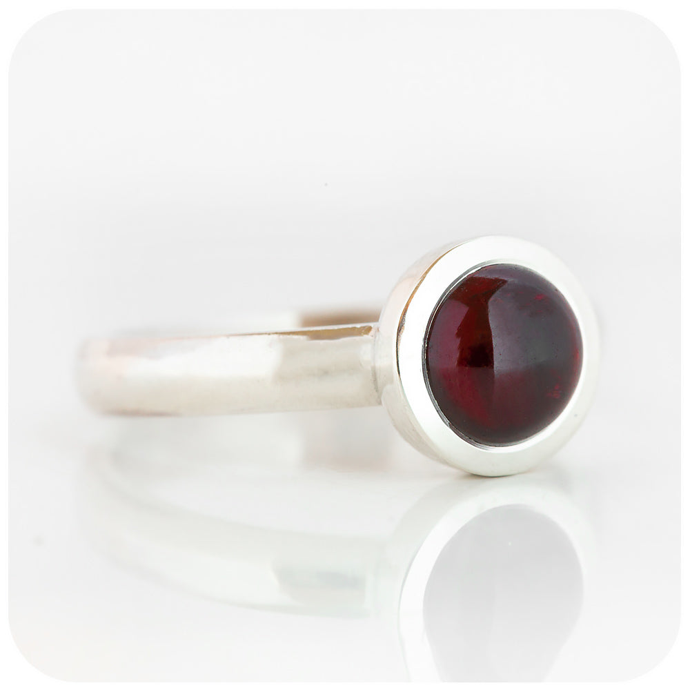 round cabochon rhodolite solitaire ring in a bezel setting