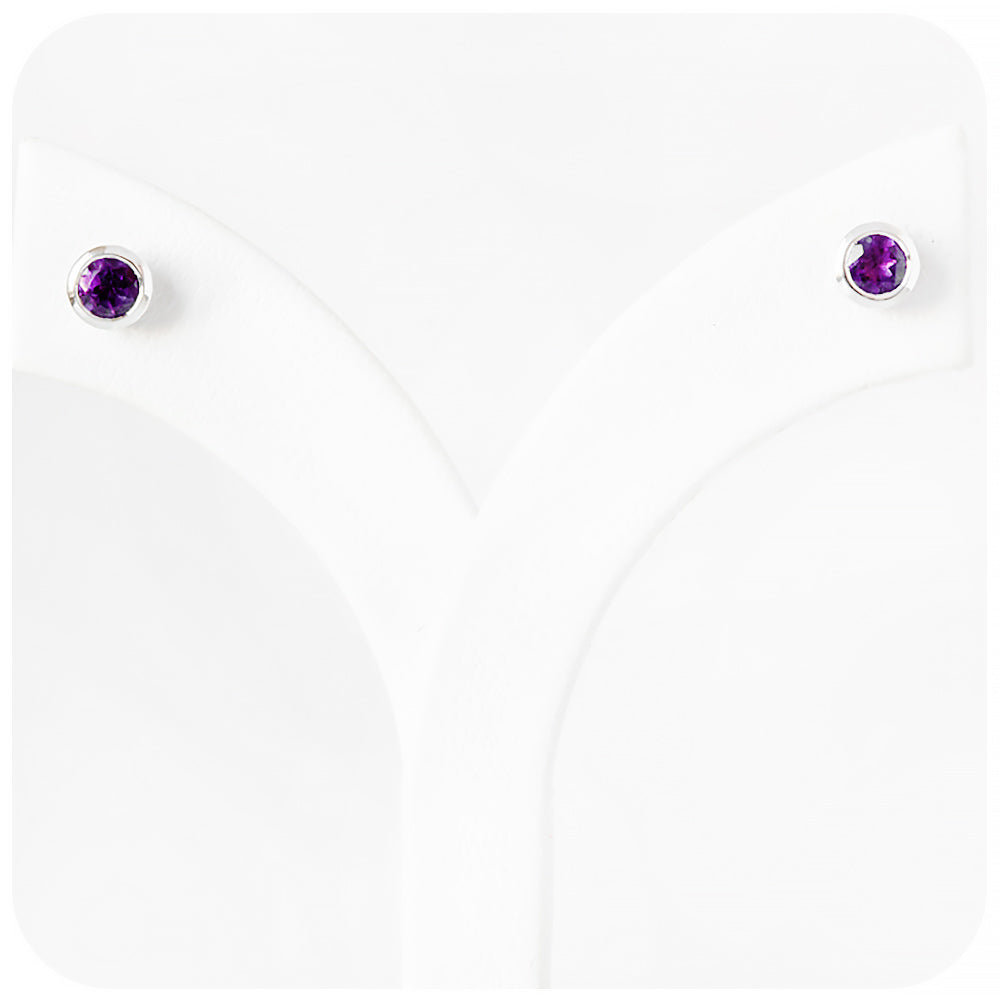 round cut purple amethyst stud earrings in a sterling silver bezel tube setting