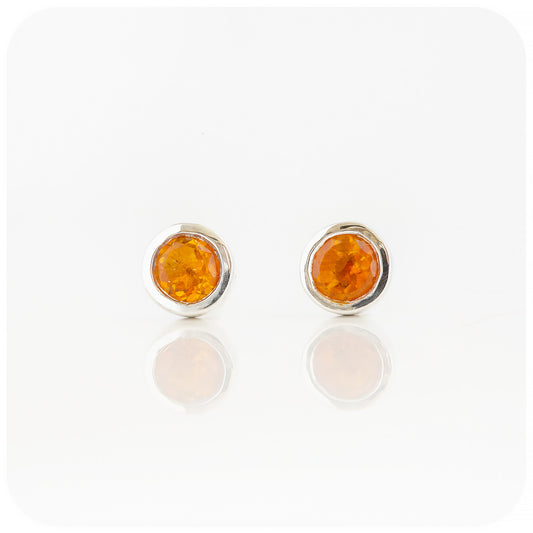 round cut yellow citrine stud earrings in a sterling silver bezel tube setting