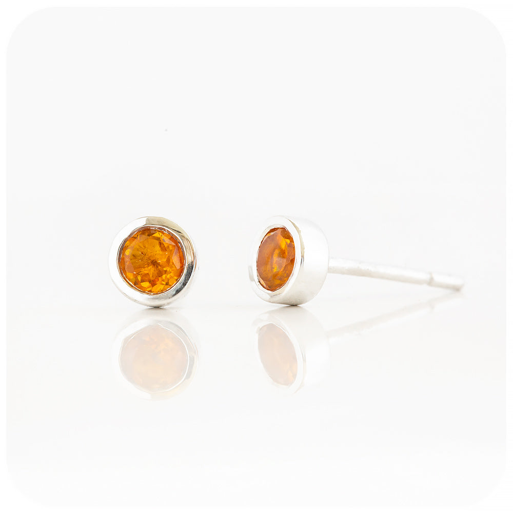 round cut yellow citrine stud earrings in a sterling silver bezel tube setting