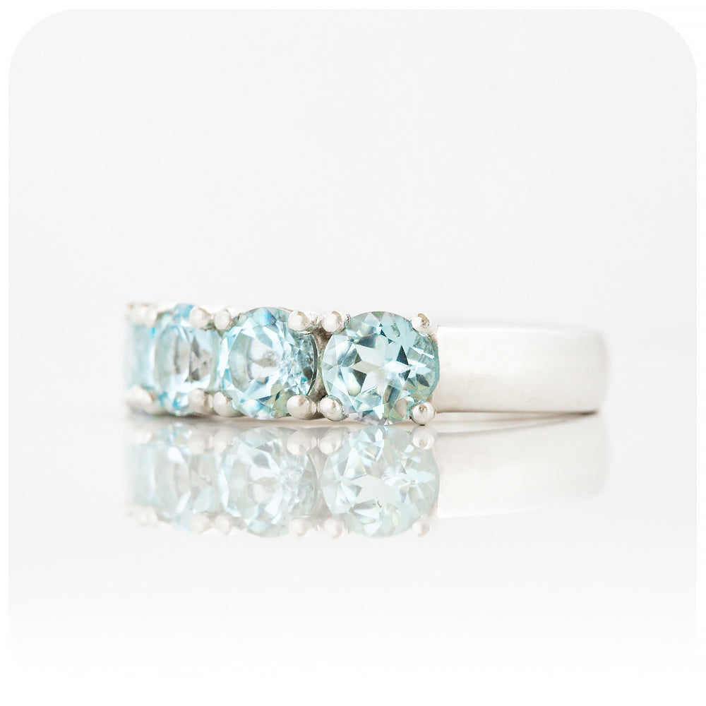 The Sky Blue Topaz Four Stone Half Eternity Ring