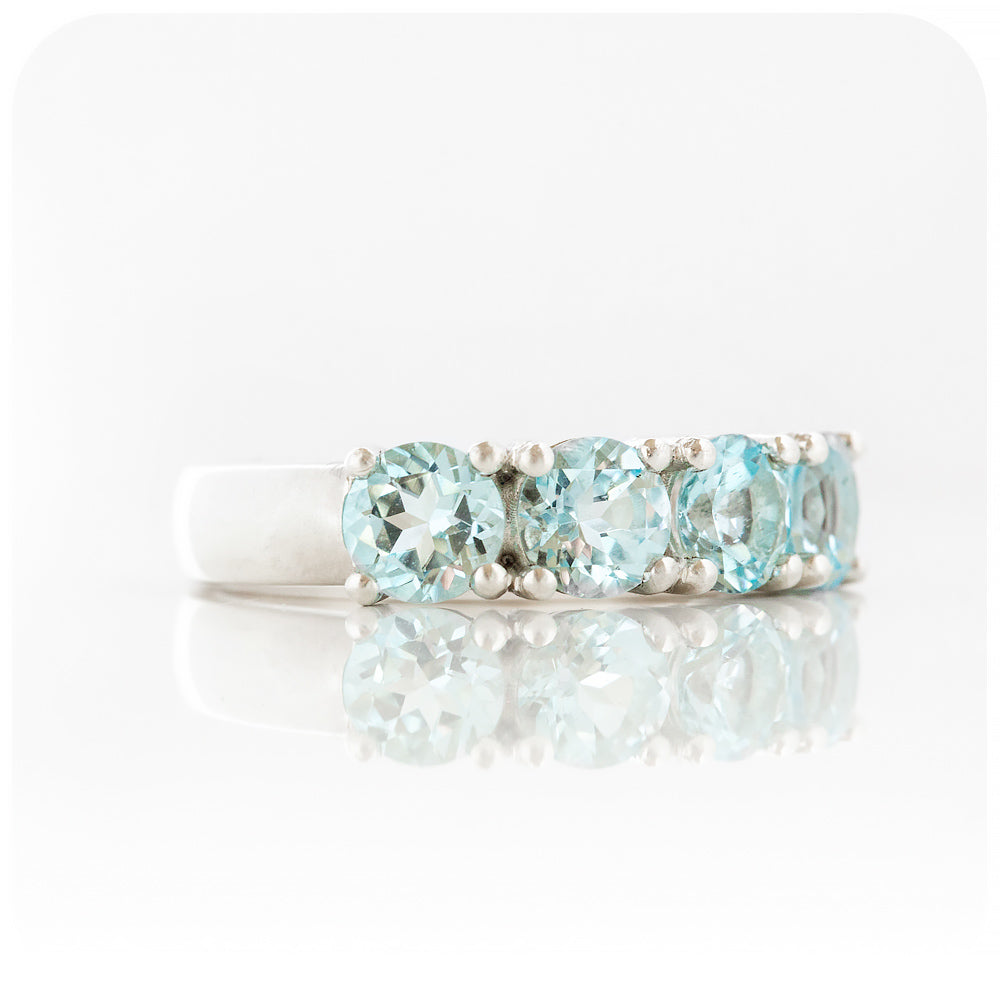 The Sky Blue Topaz Four Stone Half Eternity Ring