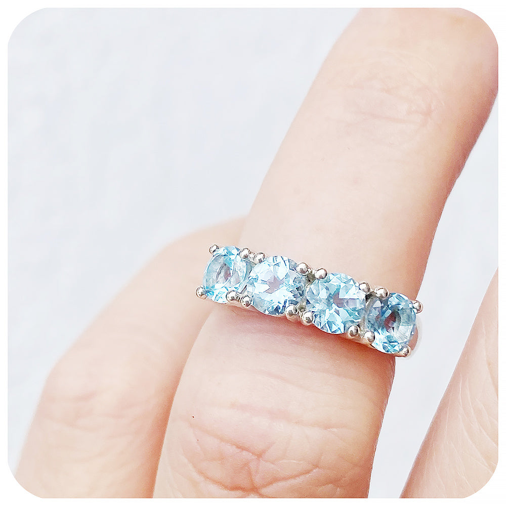 The Sky Blue Topaz Four Stone Half Eternity Ring