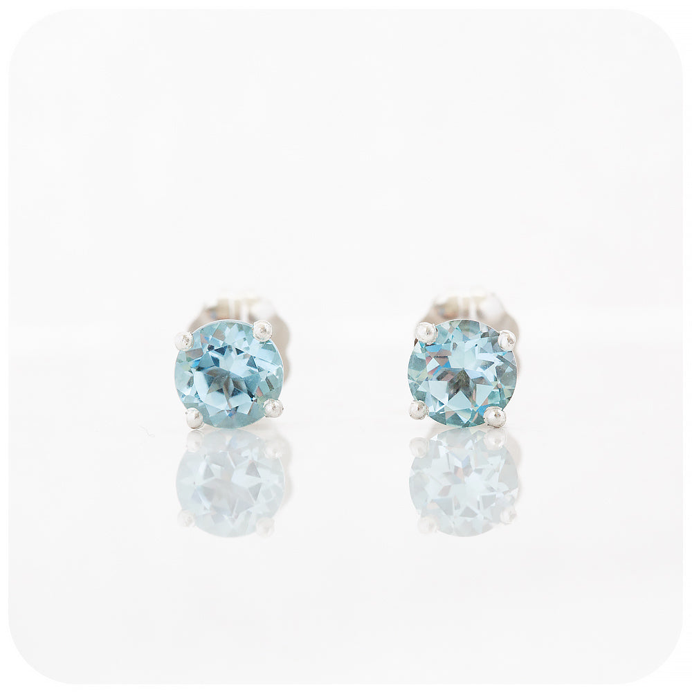 round cut light sky blue topaz stud earrings in sterling silver