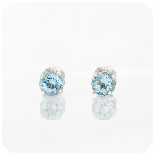 round cut light sky blue topaz stud earrings in sterling silver