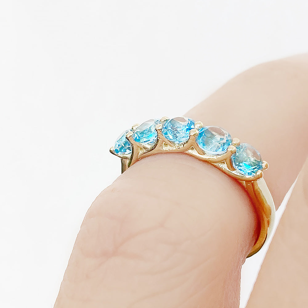 Danelle, a Swiss Blue Topaz Half Eternity Trellis Ring
