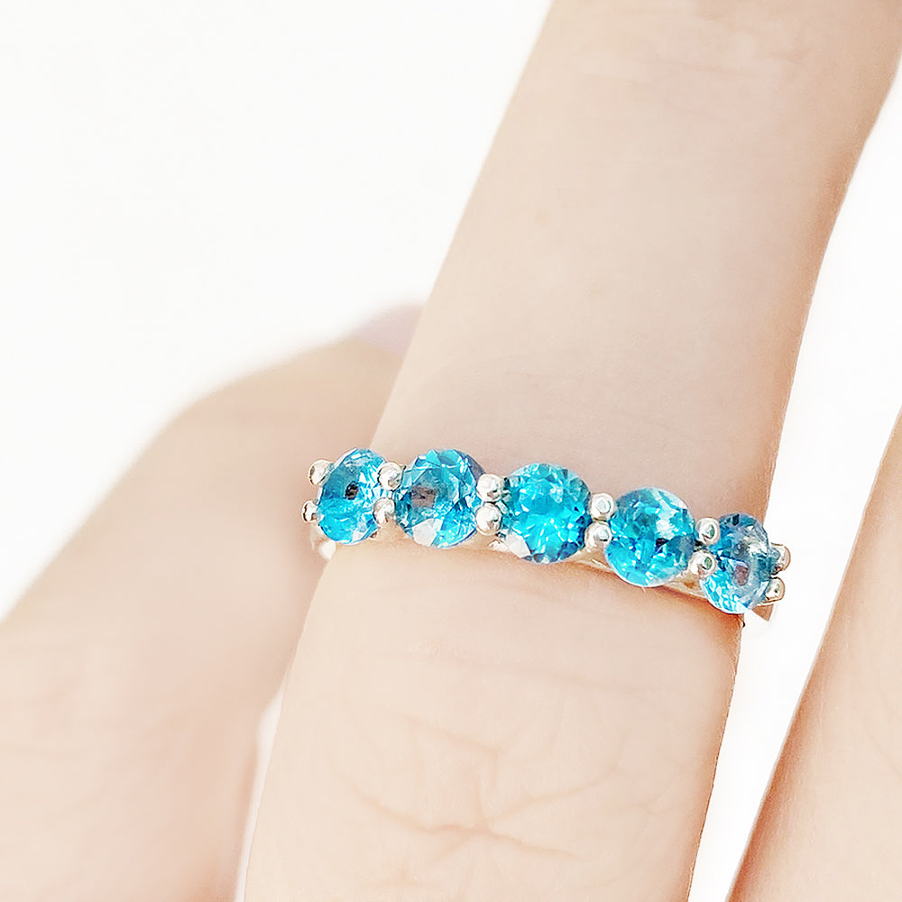 Danelle, a Swiss Blue Topaz Half Eternity Trellis Ring