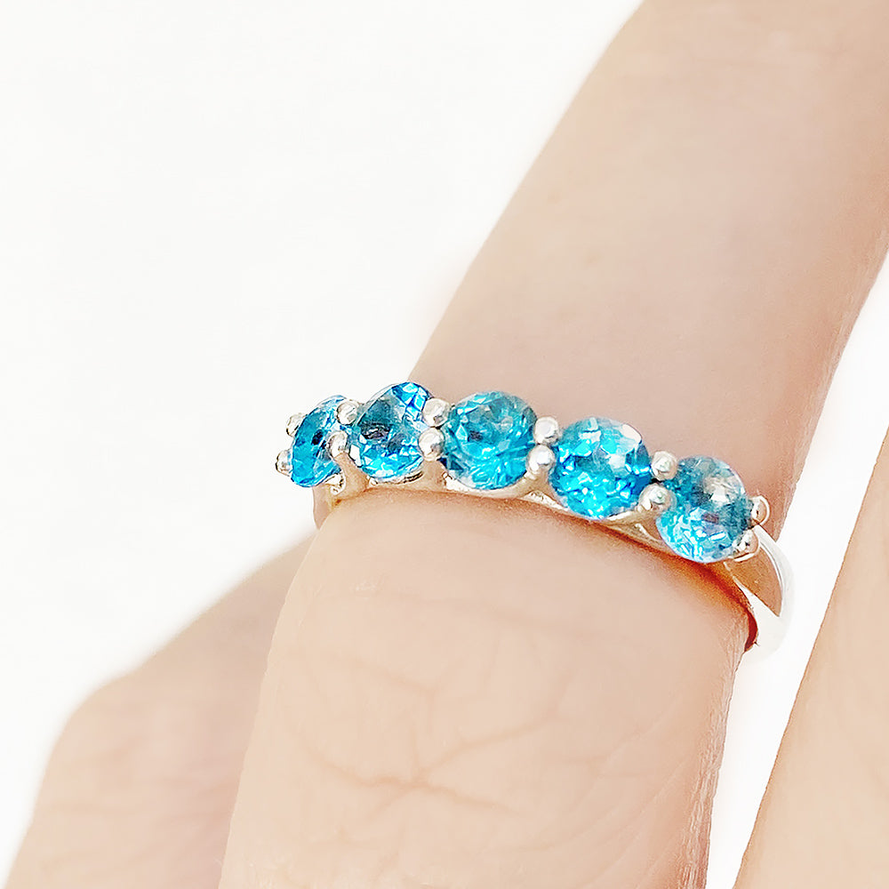 Danelle, a Swiss Blue Topaz Half Eternity Trellis Ring