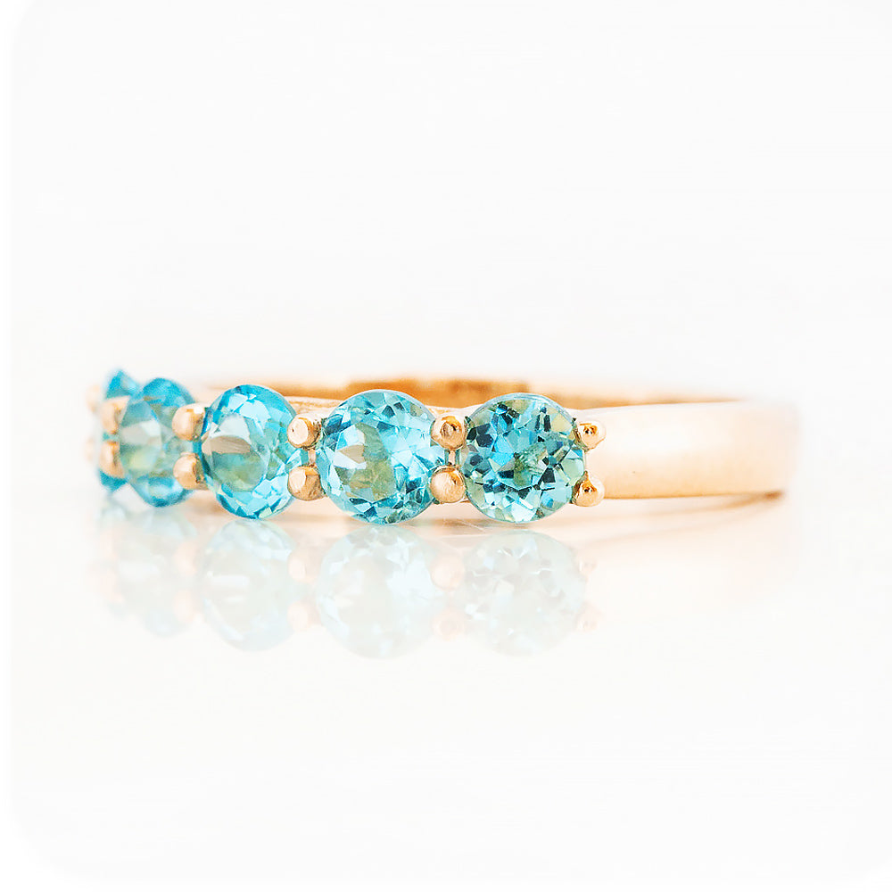Danelle, a Swiss Blue Topaz Half Eternity Trellis Ring