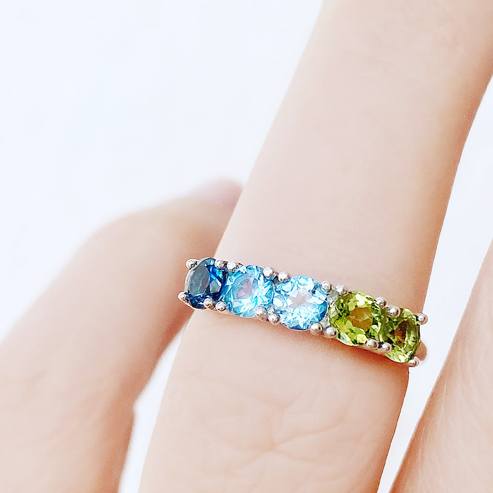 Annie, a Topaz and Peridot Half Eternity Ring