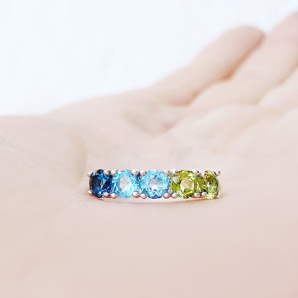 Annie, a Topaz and Peridot Half Eternity Ring