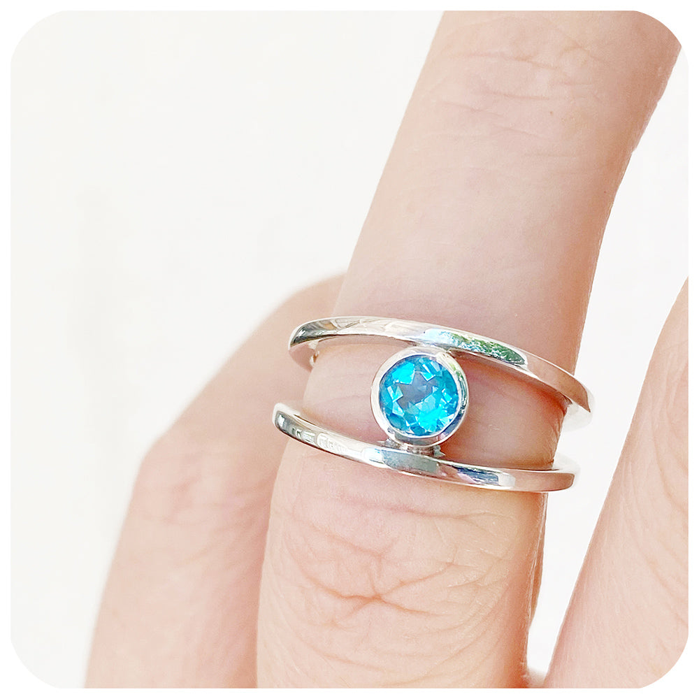 Round cut Swiss Blue Topaz Ring with a Split Band Design in Sterling Silver