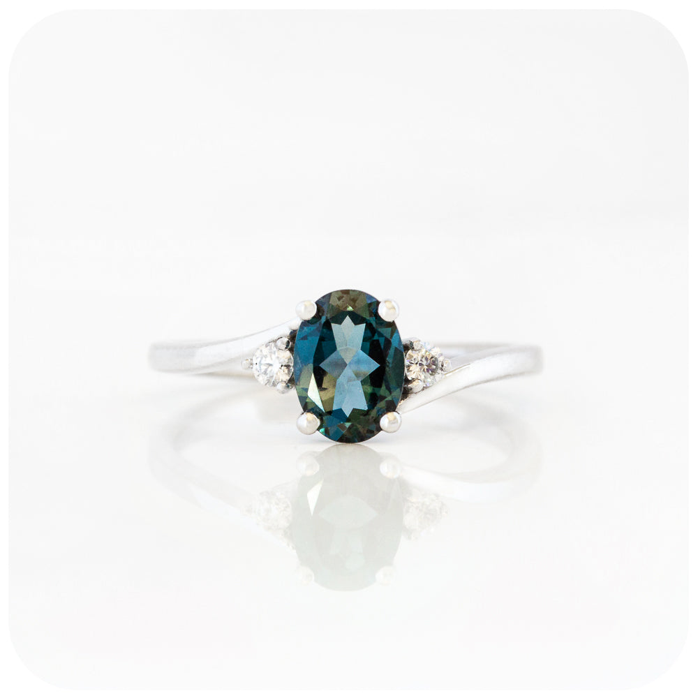 Oval cut London Blue Topaz and Moissanite Trilogy Ring with a Twist