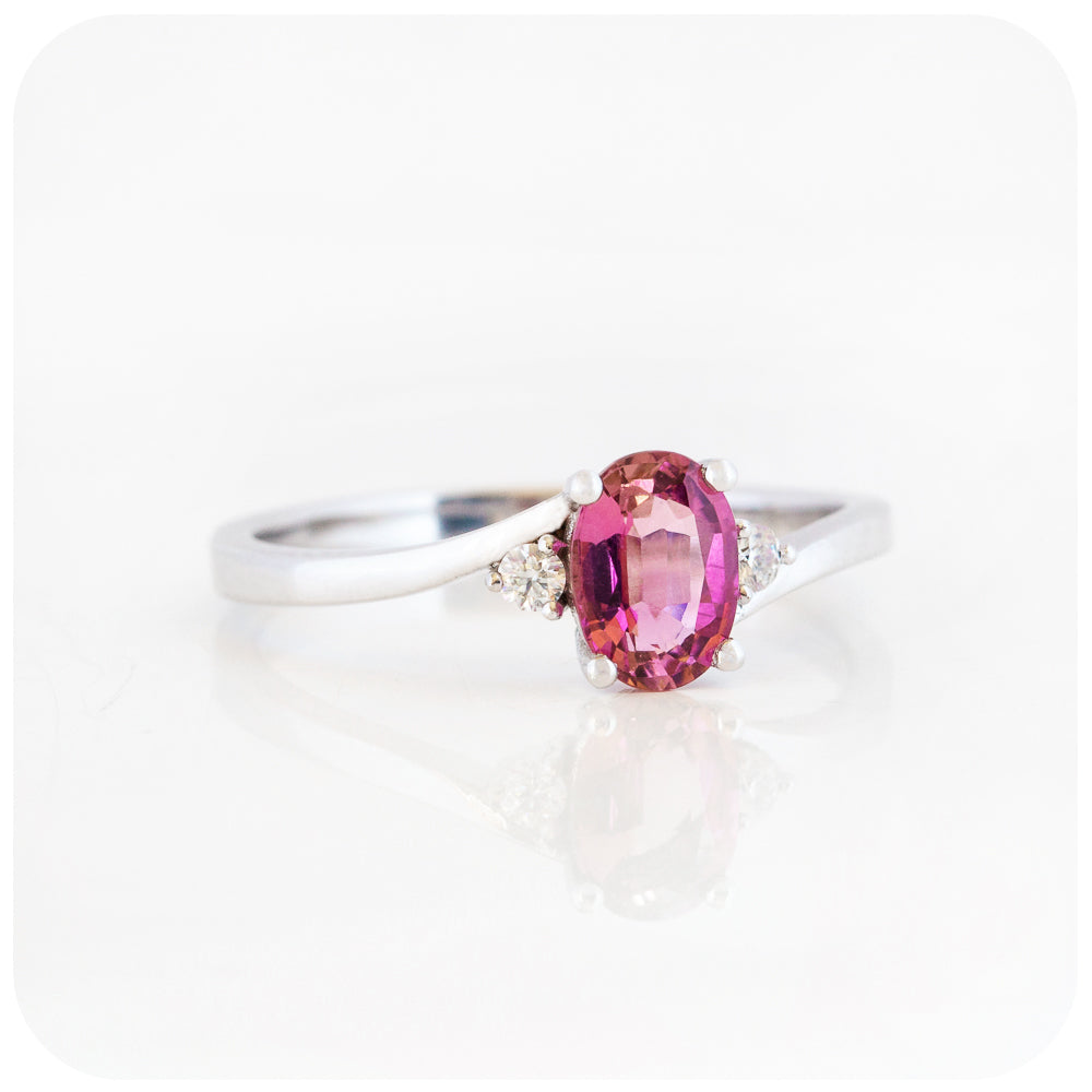 Oval cut Pink Tourmaline and Moissanite Trilogy Ring with a Twist