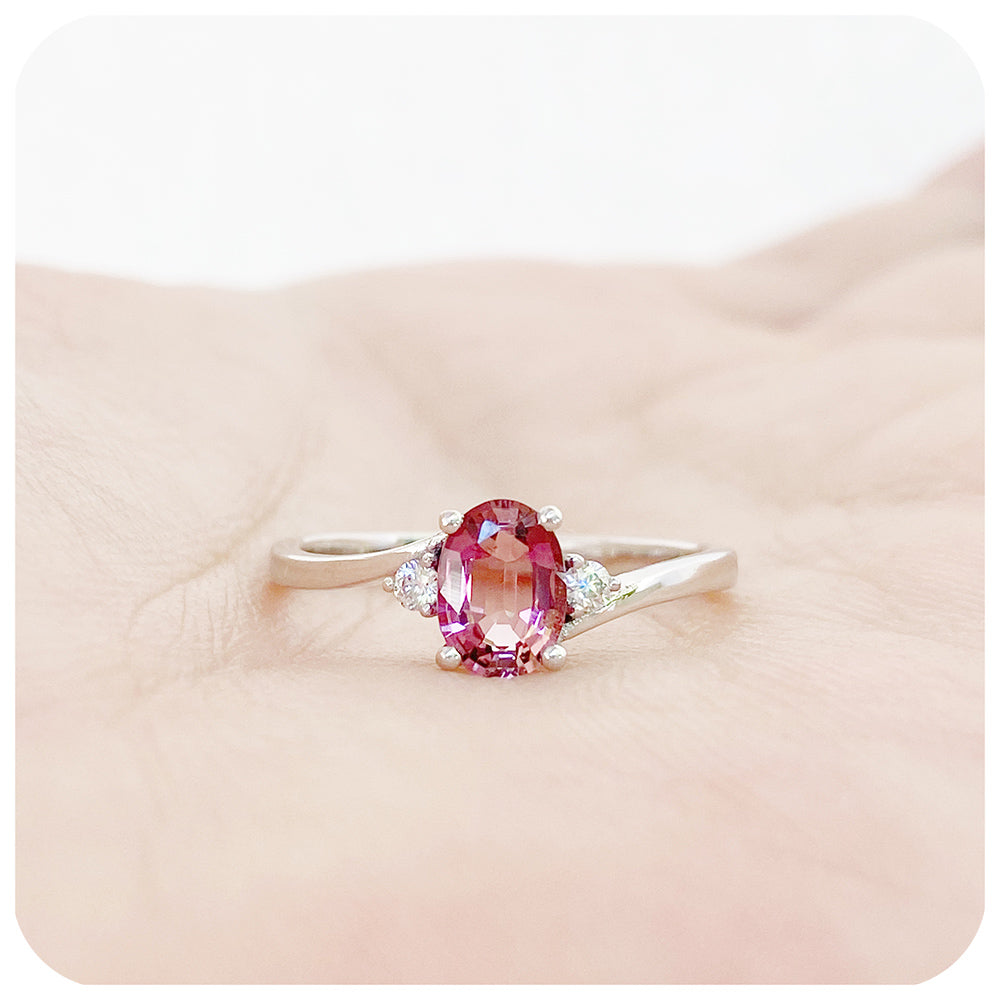 Oval cut Pink Tourmaline and Moissanite Trilogy Ring with a Twist