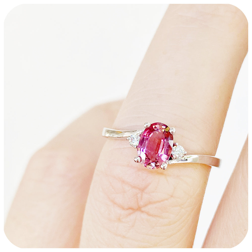 Oval cut Pink Tourmaline and Moissanite Trilogy Ring with a Twist