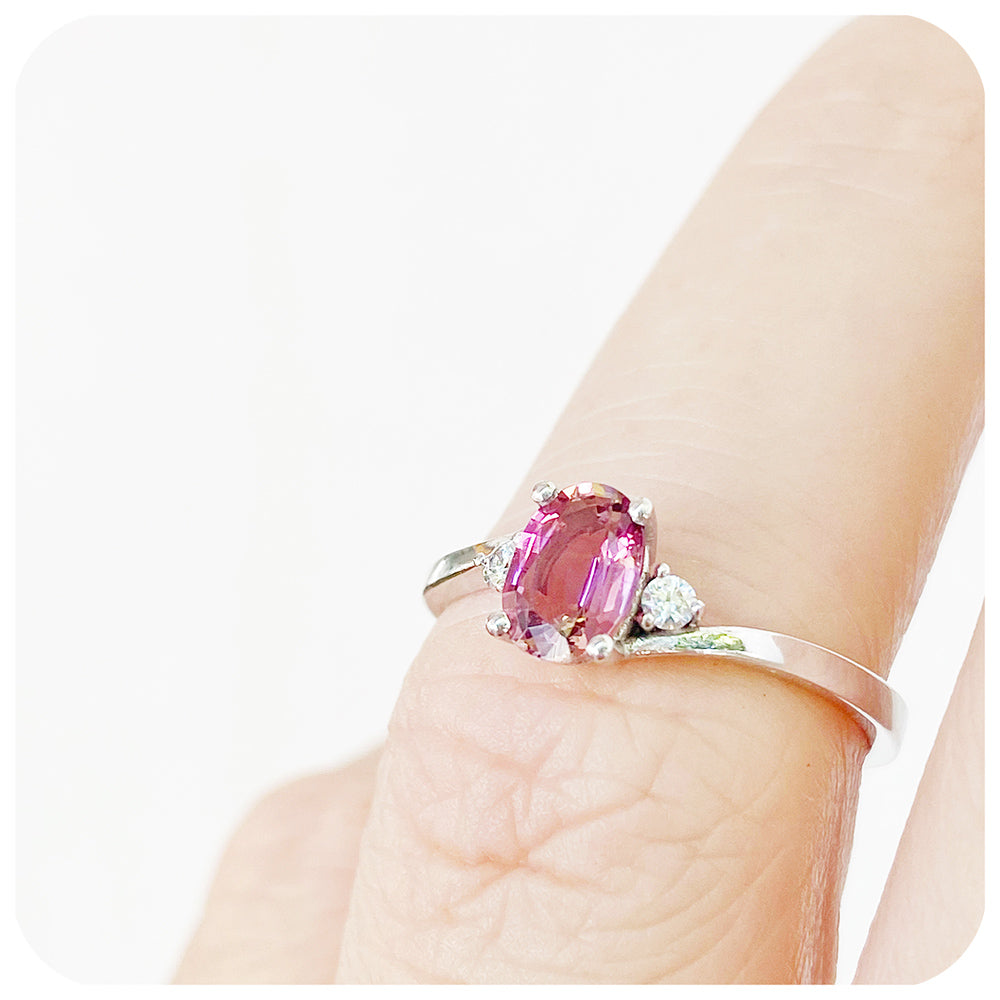 Oval cut Pink Tourmaline and Moissanite Trilogy Ring with a Twist