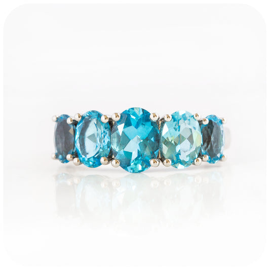 oval cut swiss blue topaz graduated half eternity anniversary or birthday ring