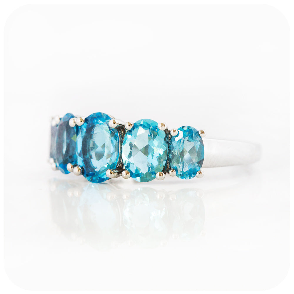 oval cut swiss blue topaz graduated half eternity anniversary or birthday ring