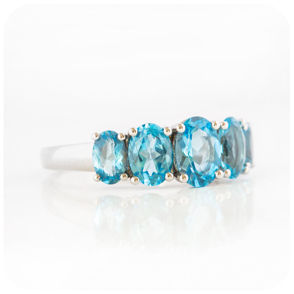oval cut swiss blue topaz graduated half eternity anniversary or birthday ring