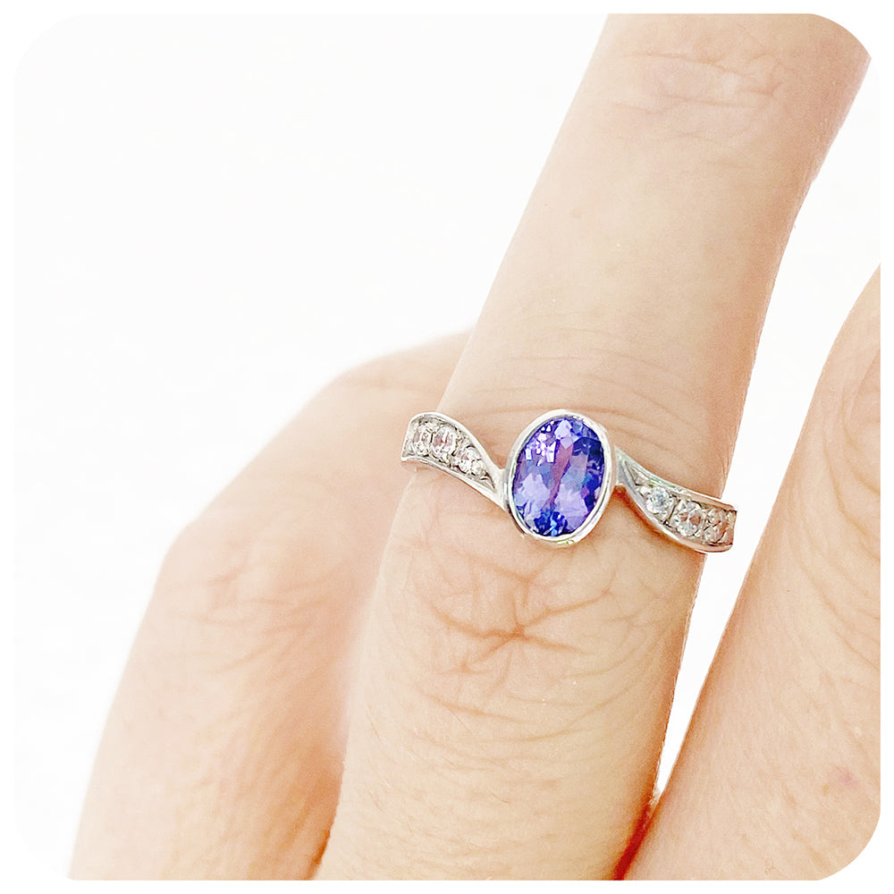 oval cut tanzanite and cubic zirconia twisted band ring in sterling silver
