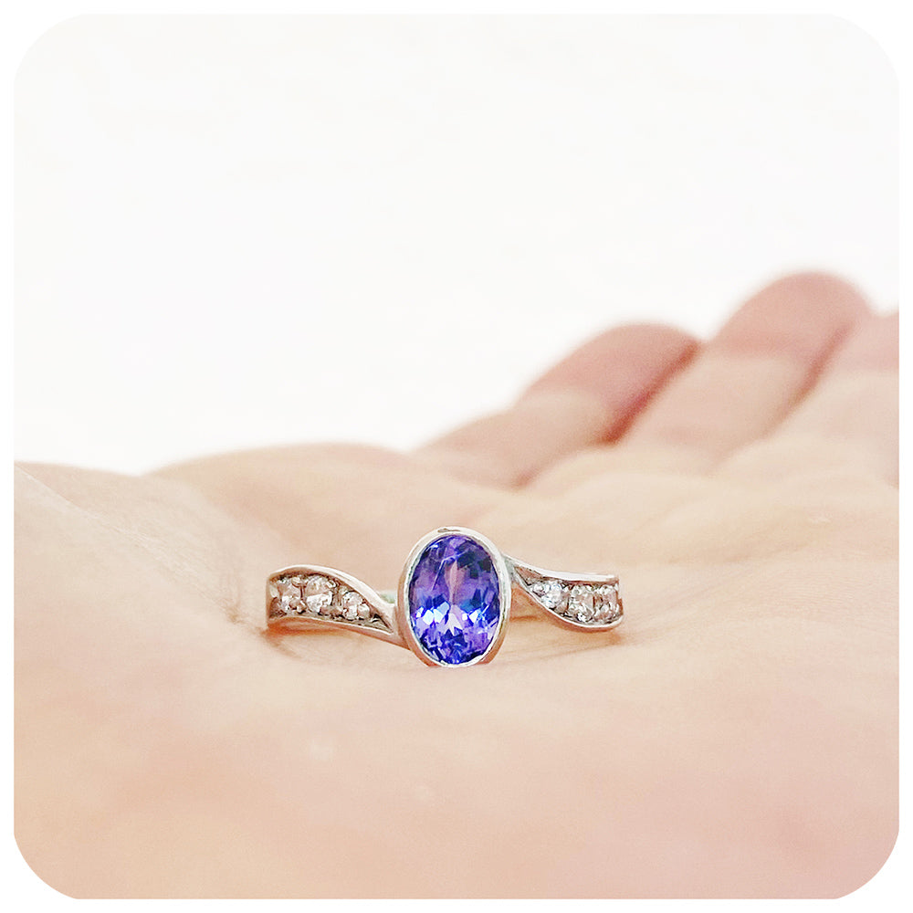 oval cut tanzanite and cubic zirconia twisted band ring in sterling silver