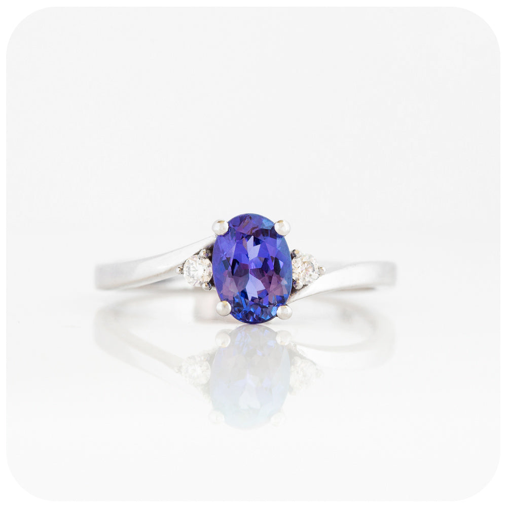 Oval cut Tanzanite and Moissanite Trilogy Ring with a Twist