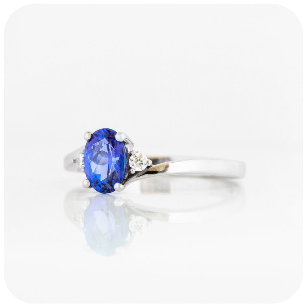 Oval cut Tanzanite and Moissanite Trilogy Ring with a Twist