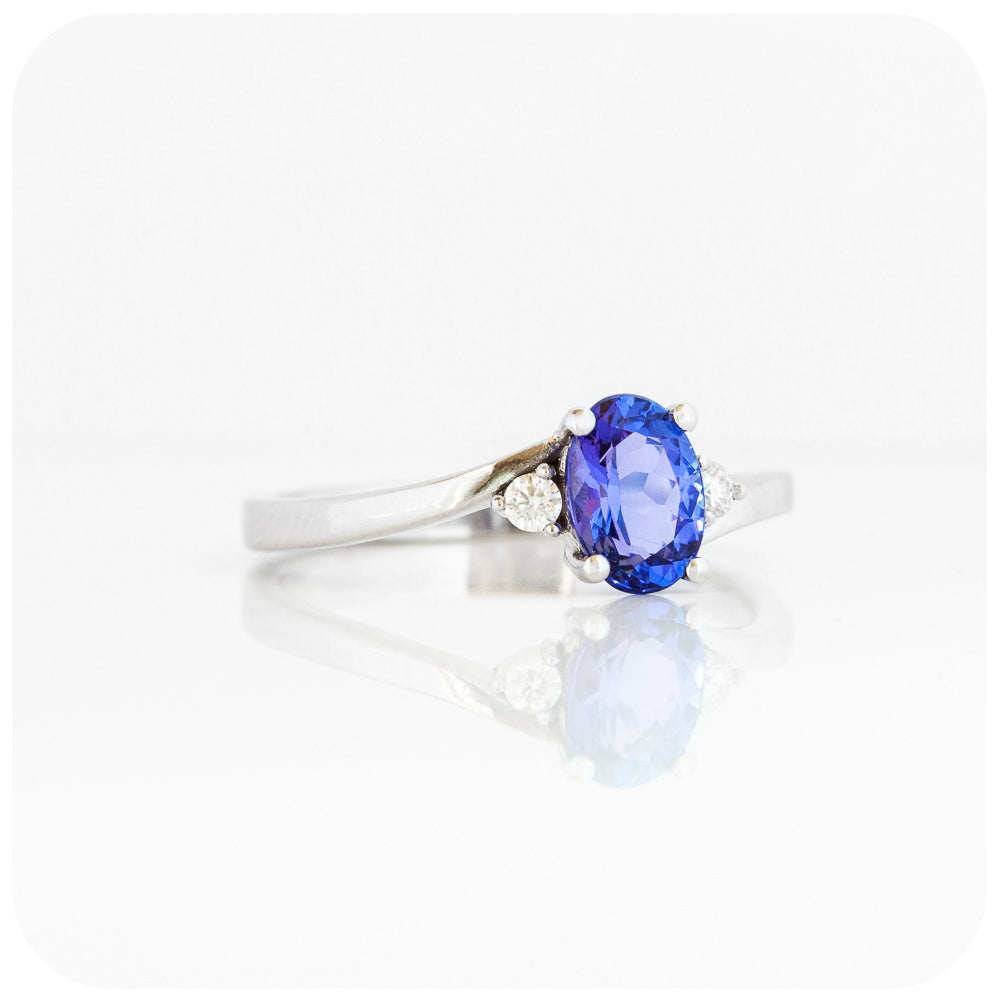 Oval cut Tanzanite and Moissanite Trilogy Ring with a Twist
