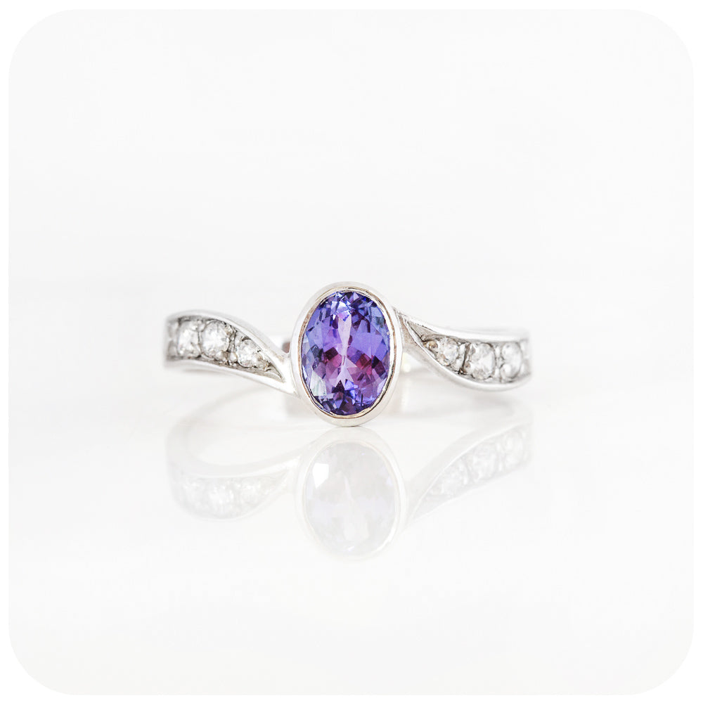 oval cut tanzanite and cubic zirconia twisted band ring in sterling silver