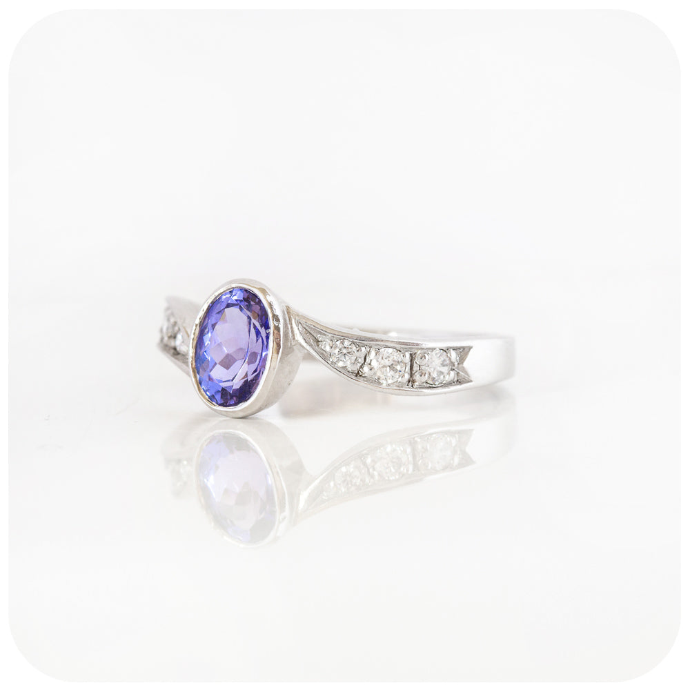 oval cut tanzanite and cubic zirconia twisted band ring in sterling silver