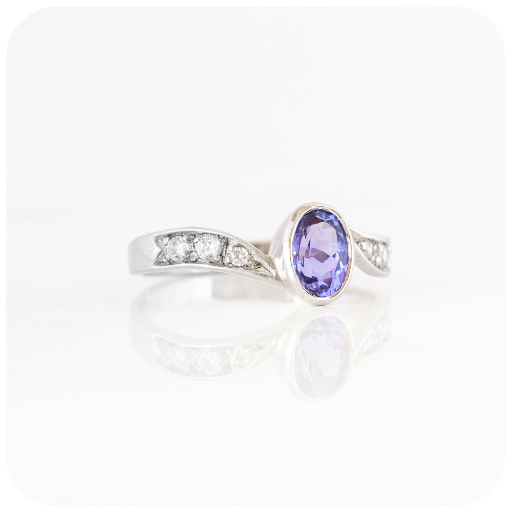 oval cut tanzanite and cubic zirconia twisted band ring in sterling silver