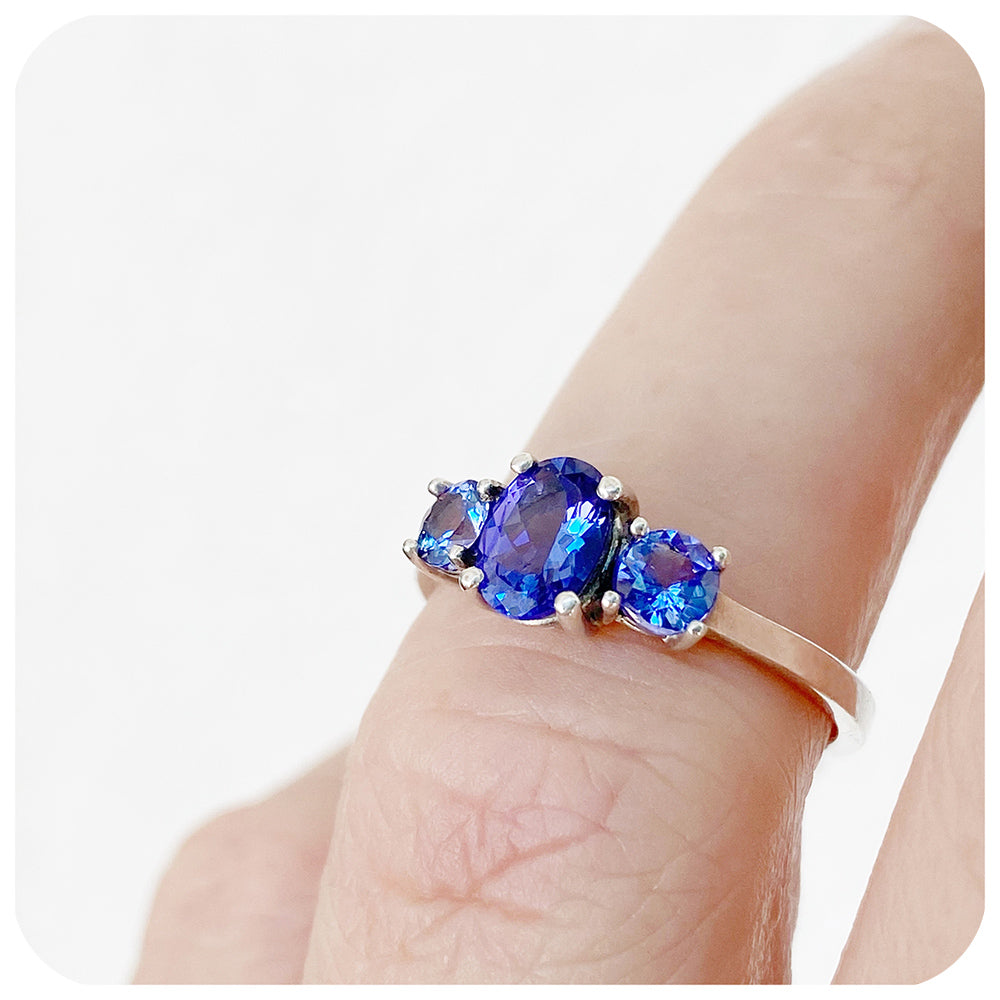 Oval and Round cut Tanzanite Trilogy Ring in Gold