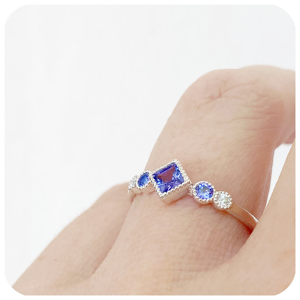 princess cut tanzanite and moissanite half eternity ring with mill grain detail - Victoria's Jewellery