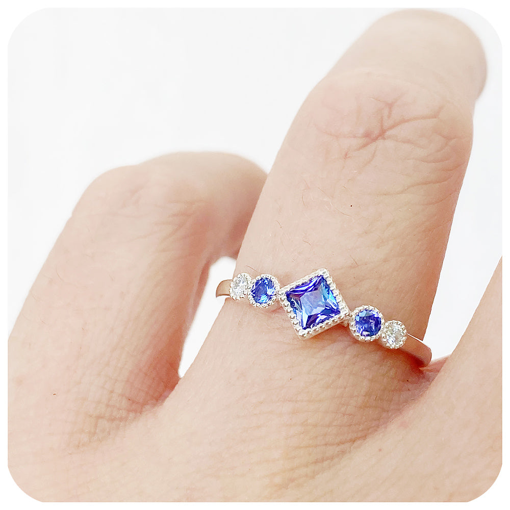princess cut tanzanite and moissanite half eternity ring with mill grain detail - Victoria's Jewellery