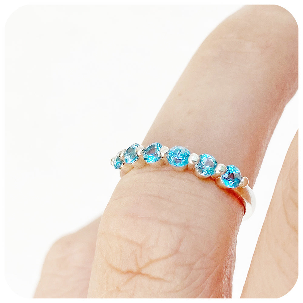 Ellie, a Swiss Blue Topaz Six Stone Half Eternity Ring
